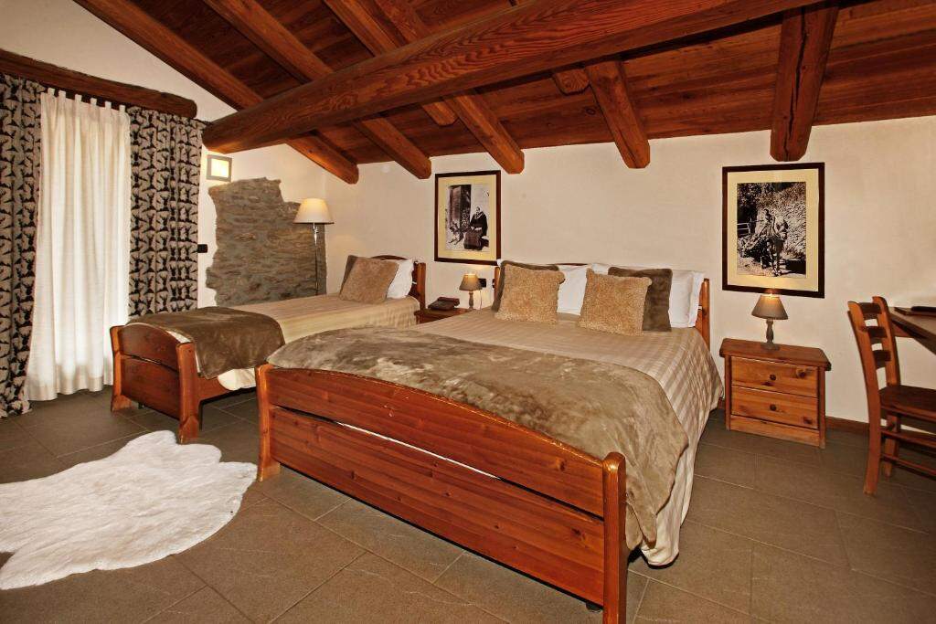 Triple Room at Chalet Faure with wooden beams and mountain decor