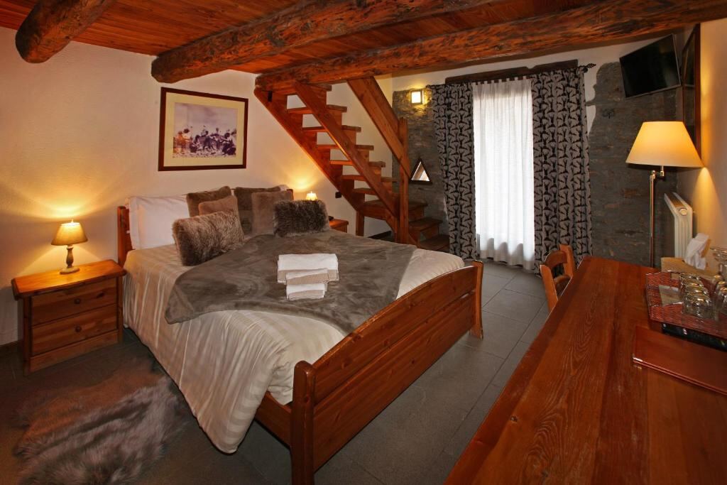 Quadruple Room at Chalet Faure with wooden furniture and large window